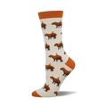 Cream crew socks with brown capybaras and small orange circles on them.  Orange cuffs.