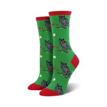 Crew socks in green with a red cuff, featuring a repeating pattern of grey cats and red berries on a green background.