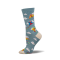 A side view of a crew sock in teal with colorful kites and white clouds. The toe and heel are off-white.