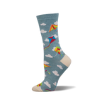 A side view of a crew sock in teal with colorful kites and white clouds. The toe and heel are off-white.