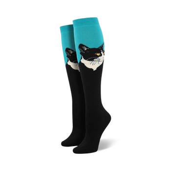 Pair of women's knee-high socks.  Black and white cat portrait on teal and red sections.  Black lower portion of socks.