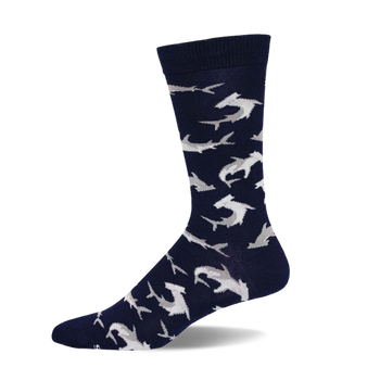 A navy blue crew sock with a pattern of light gray hammerhead sharks. The sock is shown from the side, highlighting its design and comfortable fit.