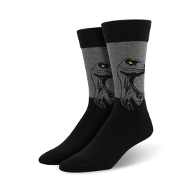 men's crew length cotton socks in black with gray band featuring dinosaur head pattern and yellow eyes.  