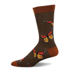 Olive green crew socks adorned with colorful monarch butterflies.  The socks have an orange and yellow butterfly design and a brown cuff.