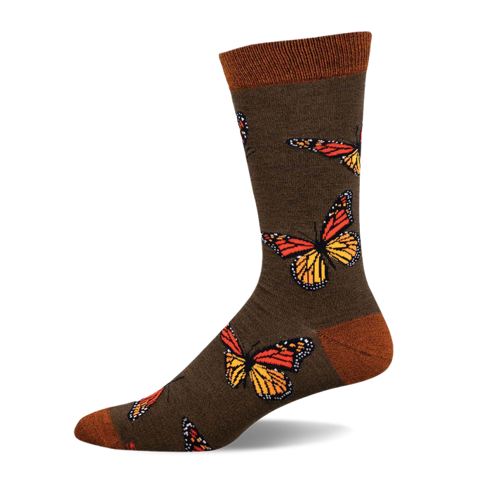 Olive green crew socks adorned with colorful monarch butterflies.  The socks have an orange and yellow butterfly design and a brown cuff. }}