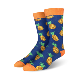 mens crew socks with an allover pattern of yellow pineapples with orange crown and green leaves on a blue background.   