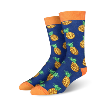 mens crew socks with an allover pattern of yellow pineapples with orange crown and green leaves on a blue background.   
