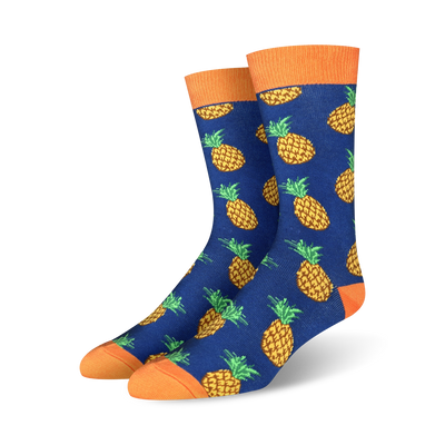 mens crew socks with an allover pattern of yellow pineapples with orange crown and green leaves on a blue background.   