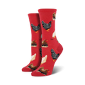 Pair of crew socks with chicken pattern on a red background.