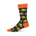 Crew sock with black background, orange cuff, heel, and toe, patterned with yellow jack-o'-lanterns and white spooky faces.