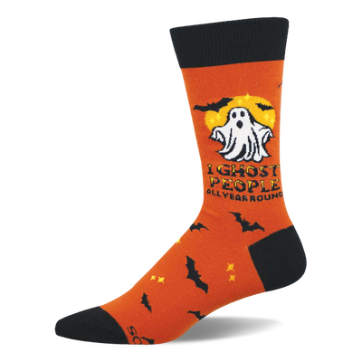 Orange crew sock with a white cartoon ghost, yellow full moon, black bats, and "I Ghost People All Year Round" text.