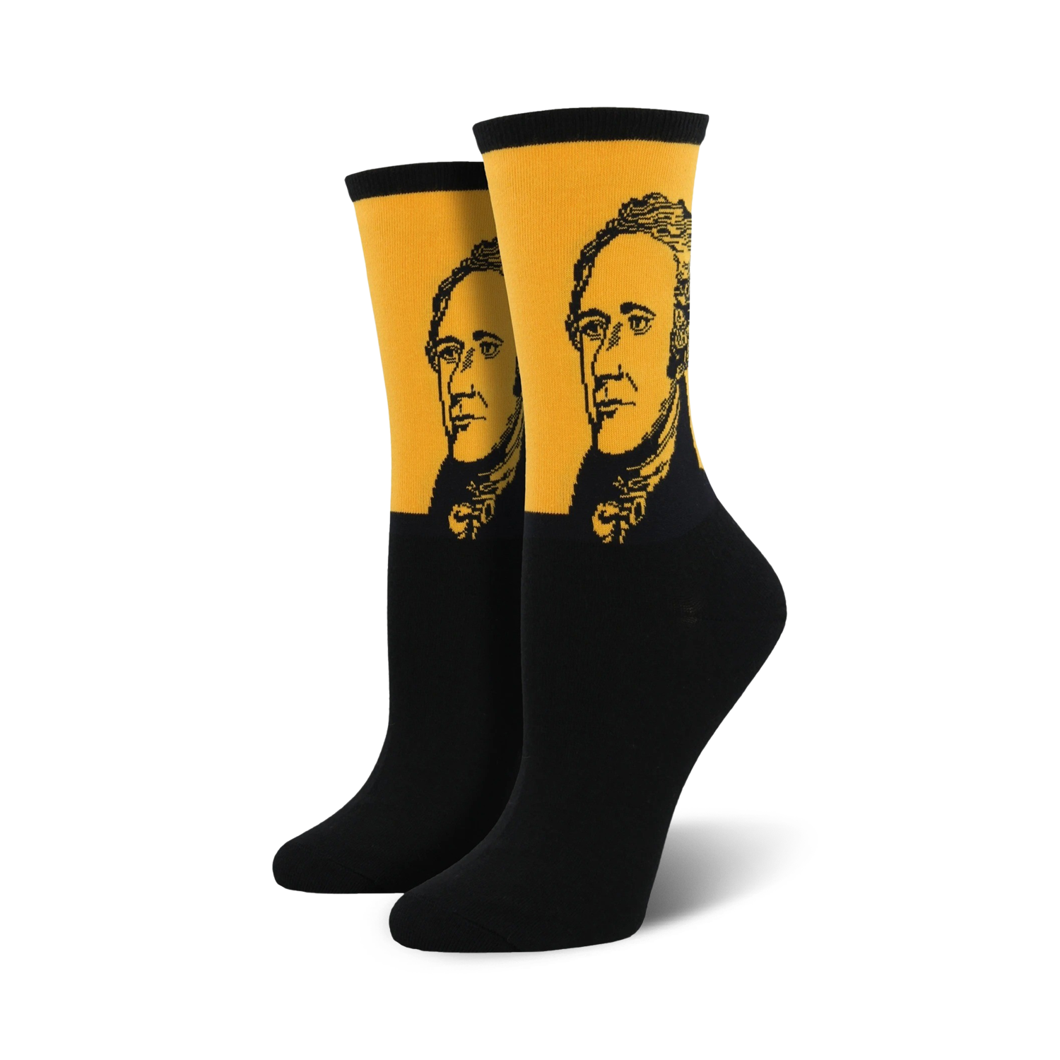 Pair of black and gold crew socks featuring a portrait of Alexander Hamilton. The socks have a mustard yellow band with a black and white illustration of Hamilton's face.