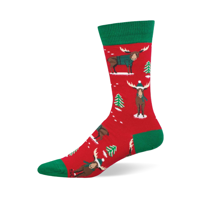 Red crew socks with green accents, featuring festive moose in teal sweaters and beanies, plus green Christmas trees and white snow. }}
