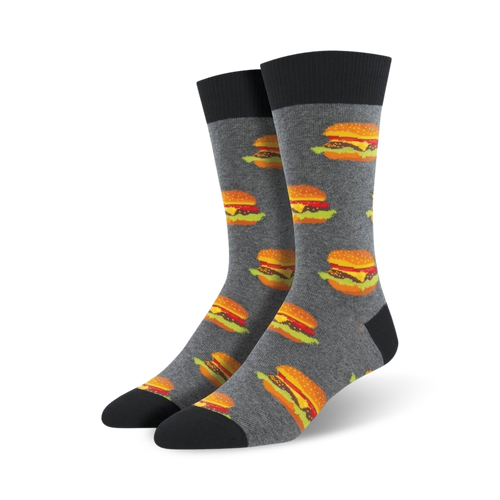 Pair of gray crew socks with repeating images of juicy cheeseburgers.  Black cuff and toes. Fun, food-themed design.