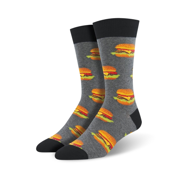 gray crew socks featuring a pattern of classic hamburgers with brown buns, green lettuce, orange cheese, and red ketchup. made for men.    }}