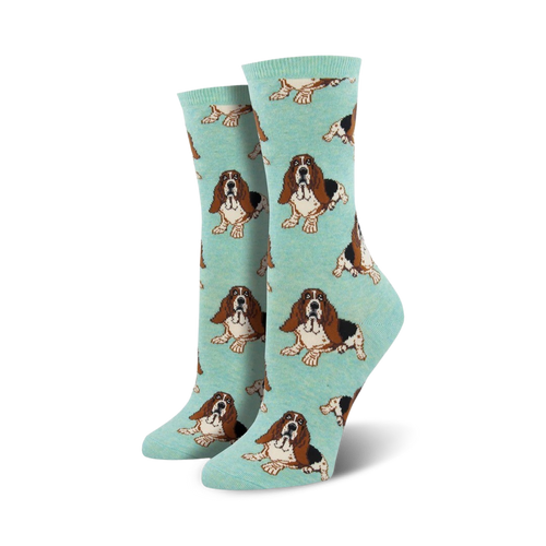 Pair of teal women's crew socks with a repeating basset hound pattern. Lifestyle shot showing the socks on a model's feet.