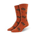 Pair of orange crew socks featuring a repeating pattern of turkeys and pitchforks.