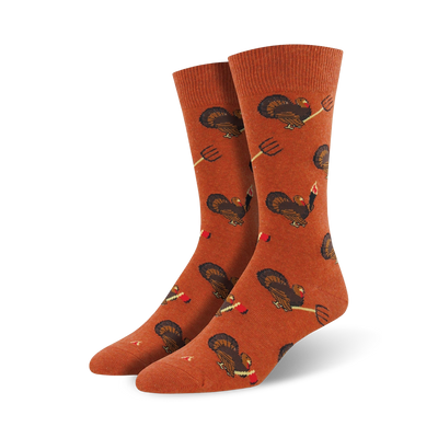 orange crew socks featuring cartoon turkeys holding pitchforks and drumsticks, thanksgiving theme, mens.  