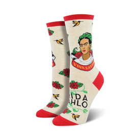 white novelty crew socks feature frida kahlo portrait, surrounded by red roses, green leaves, yellow birds, and the words "viva la frida".  