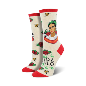 white novelty crew socks feature frida kahlo portrait, surrounded by red roses, green leaves, yellow birds, and the words "viva la frida".  