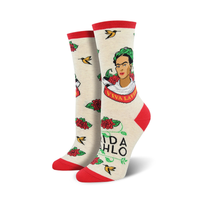 white novelty crew socks feature frida kahlo portrait, surrounded by red roses, green leaves, yellow birds, and the words "viva la frida".  