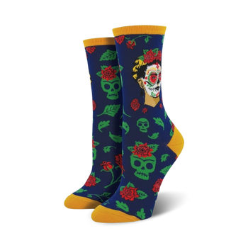 dia de los frida crew socks for women feature frida kahlo's face and floral skull pattern in red, green, and light blue.   