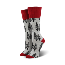 women's boot socks featuring a gray body with a pattern of black pine trees. the sock has a solid red top.  