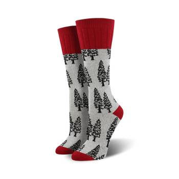 women's boot socks featuring a gray body with a pattern of black pine trees. the sock has a solid red top.  