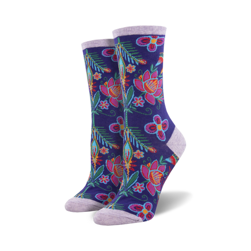 Pair of women's crew socks with a vibrant floral print.  Dark purple base with pink, teal, and orange flowers and leaves.
