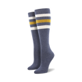 Pair of light blue knee-high socks with a vibrant rainbow striped cuff against a white background.