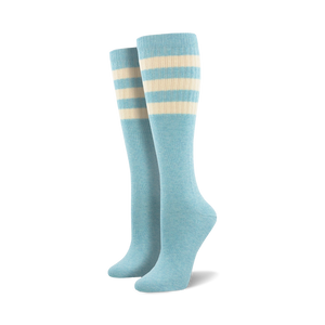 Pair of light blue knee-high socks with a vibrant rainbow striped cuff against a white background.
