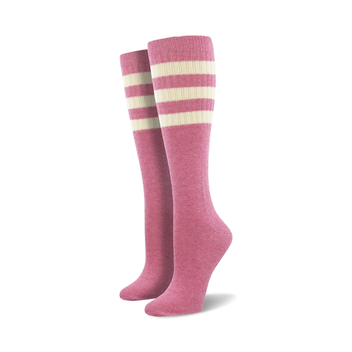 Pair of light blue knee-high socks with a vibrant rainbow striped cuff against a white background.
