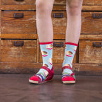 Lifestyle shot of a person wearing the ramen socks with sandals. [lf]