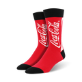 coca-cola socks in crew length, made for men with red color and a black toe/heel. the word coca-cola is splashed across the front in white.  