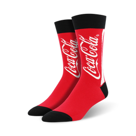 coca-cola socks in crew length, made for men with red color and a black toe/heel. the word coca-cola is splashed across the front in white.  
