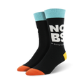 Pair of black crew socks with a teal cuff and orange toe.  The socks feature large white lettering that says 'NO BS' and small text that says '*Boring Socks'.