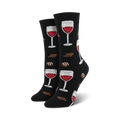 Pair of black crew socks with a pattern of red wine glasses and chocolate pieces. Fun and whimsical design.