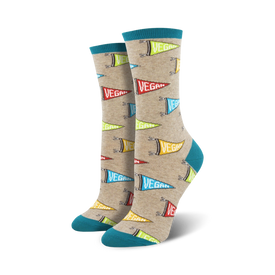 crew-length women's socks with a light beige background and a repeating pattern of multicolor triangular pennant flags with the word "vegan" on them in a fun food & drink theme.  