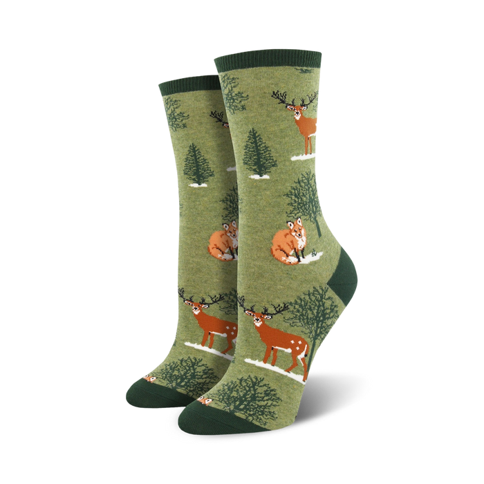 womens crew socks in dark green with a pattern of foxes and deer in a snowy forest.  