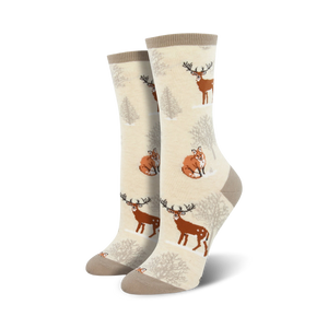 cotton crew socks feature a pattern of deer and foxes in the snowy woods.  