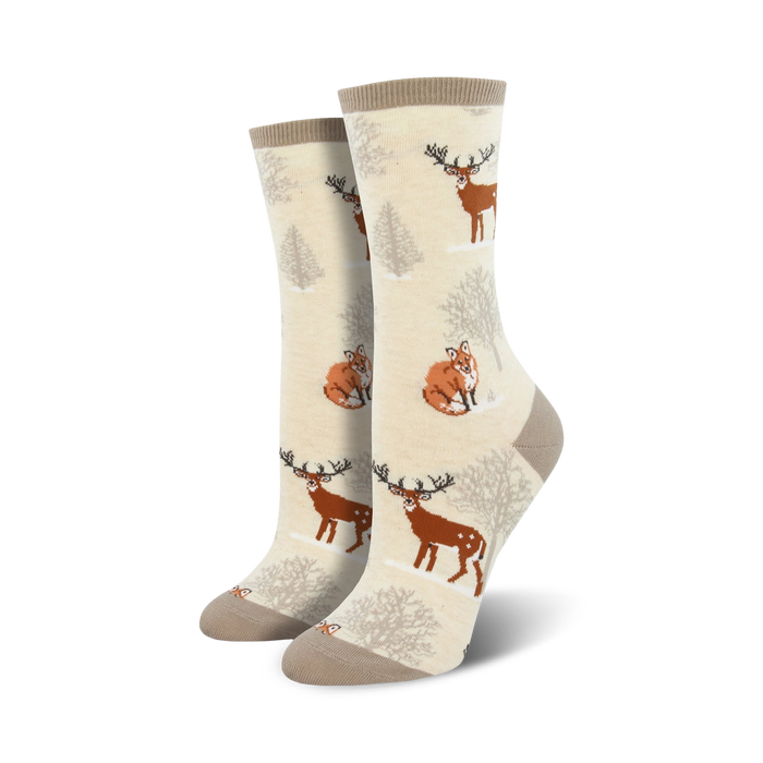 cotton crew socks feature a pattern of deer and foxes in the snowy woods.  