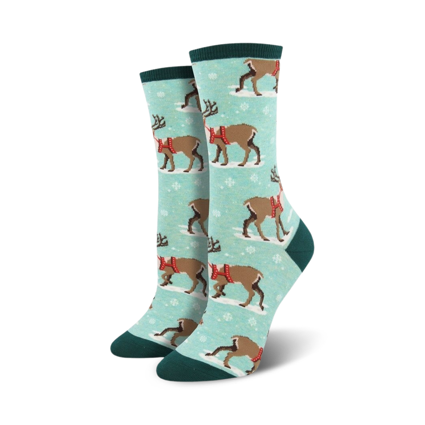 Lifestyle shot of a person's feet wearing teal Winter Reindeer socks. The background shows snow and nature.
