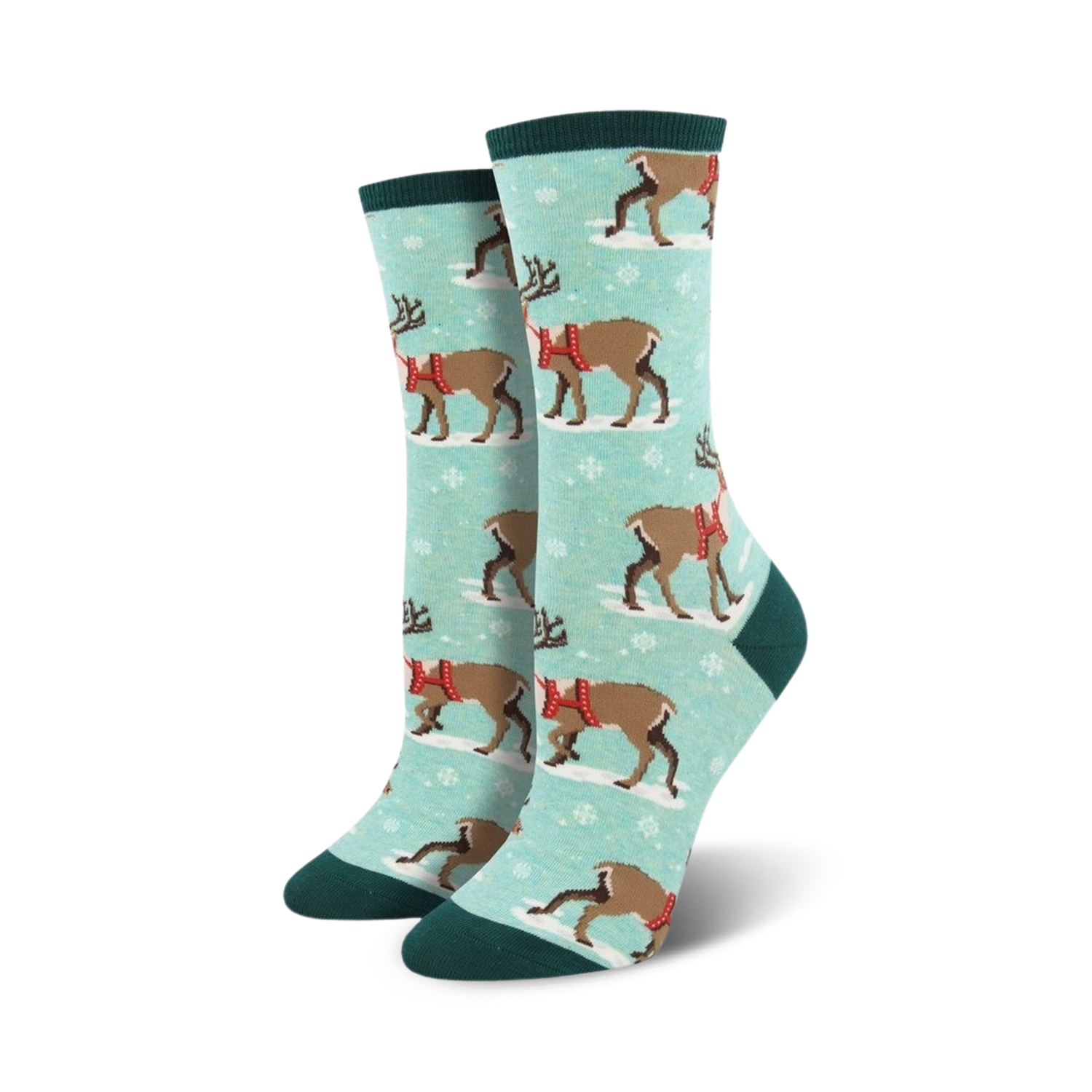 Lifestyle shot of a person's feet wearing teal Winter Reindeer socks. The background shows snow and nature.