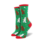 Close-up of a green Mythical Kissmas sock with red cuff, showing the Bigfoot and Yeti design detail.