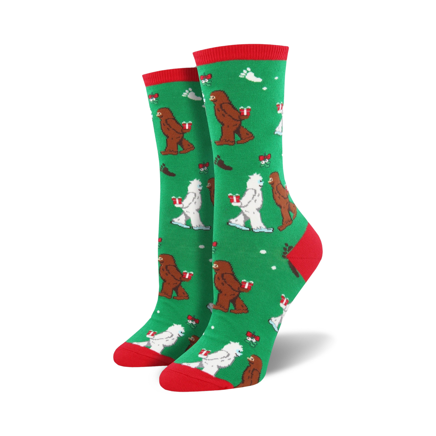 Close-up of a green Mythical Kissmas sock with red cuff, showing the Bigfoot and Yeti design detail.
