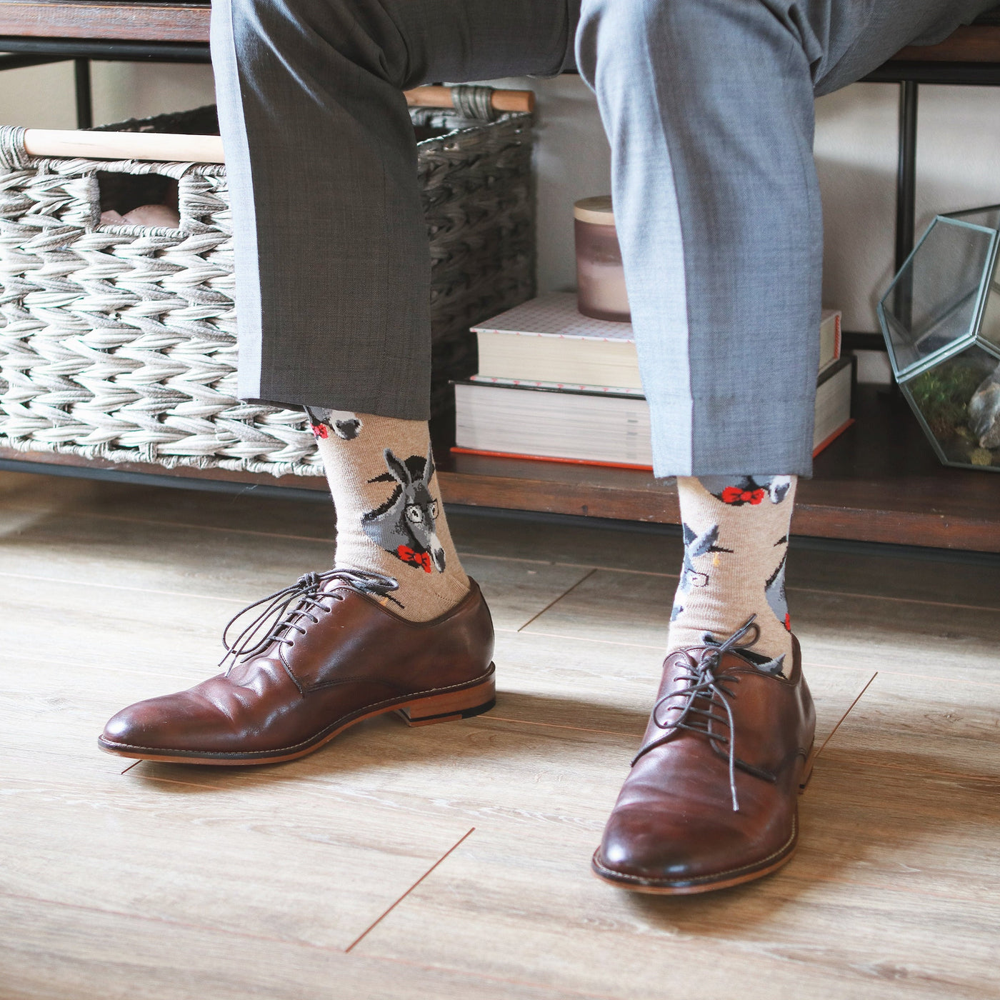 Lifestyle shot: A person wearing tan donkey socks with brown leather shoes. [lf]