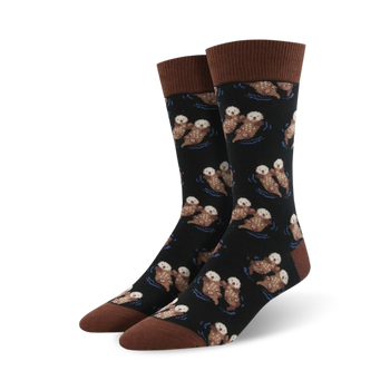 fun black crew socks for men feature otters holding hands and a dark blue ocean background.  