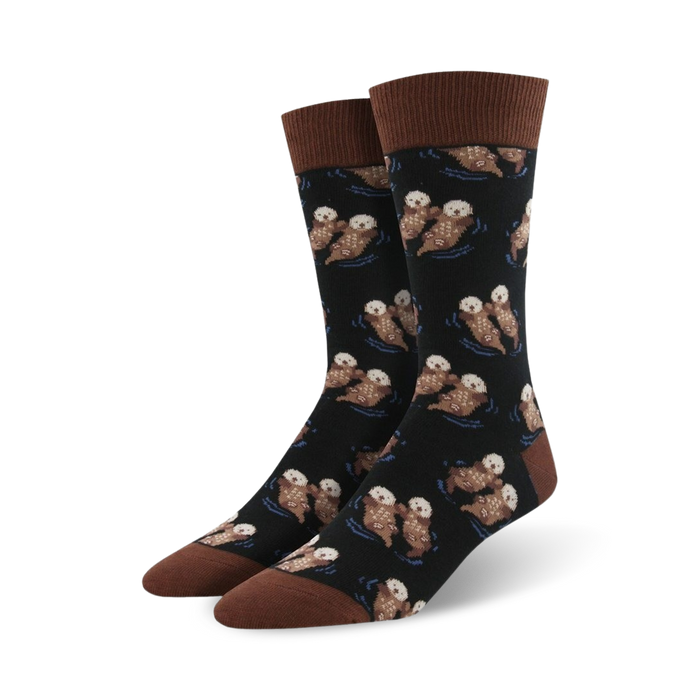 fun black crew socks for men feature otters holding hands and a dark blue ocean background.  