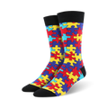 Pair of crew socks with a puzzle-piece design. The socks are predominantly red, yellow, blue, and teal.