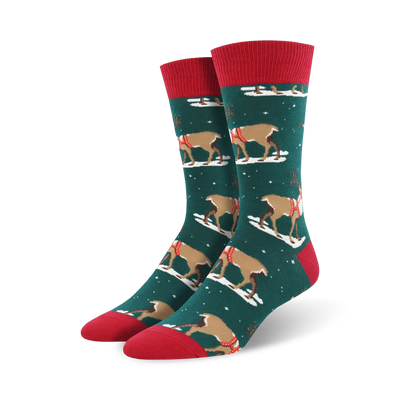 dark green crew socks with a festive pattern of reindeer in red and white saddles prancing on a snowy white background. perfect for the holidays!  